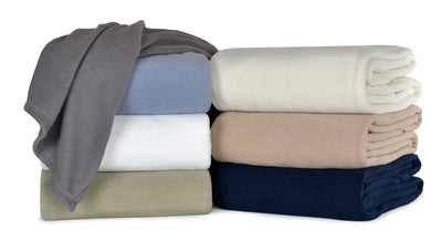 Different color blankets folded and stacked.