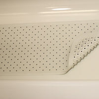 Rubber bath mat with suction cups in a tub