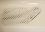 Rubber bath mat with suction cups in a tub