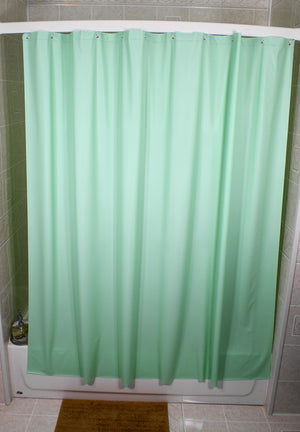 Green Vinyl Shower curtain hanging on a shower curtain rod. 