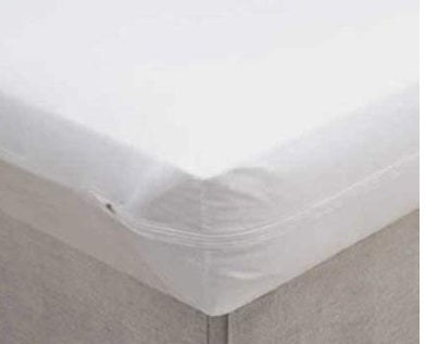 Corner of a bed with a Vinyl Zippered Mattress cover on it.