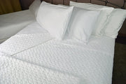 Bed made with Quilted Impressions Double Diamond Coverlet